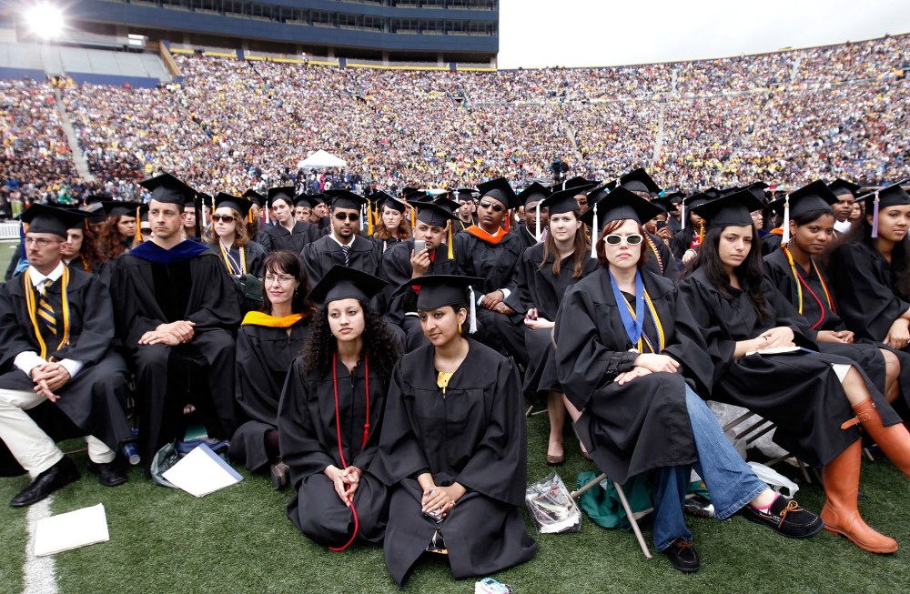 Graduating students listen to U.S. President Obama speak during commencement at the University of Michigan