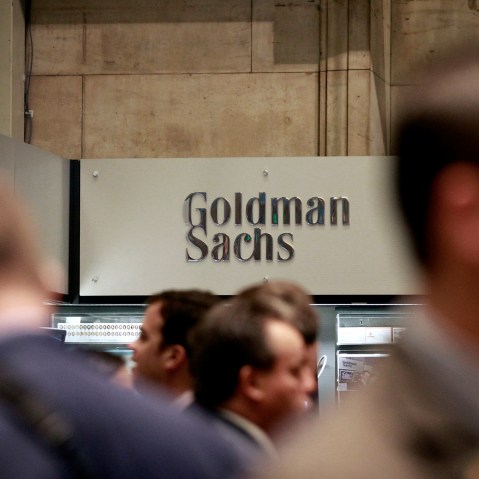 Traders work on the floor of the New York Stock Exchange near the Goldman Sachs stall on July 16, 2010.