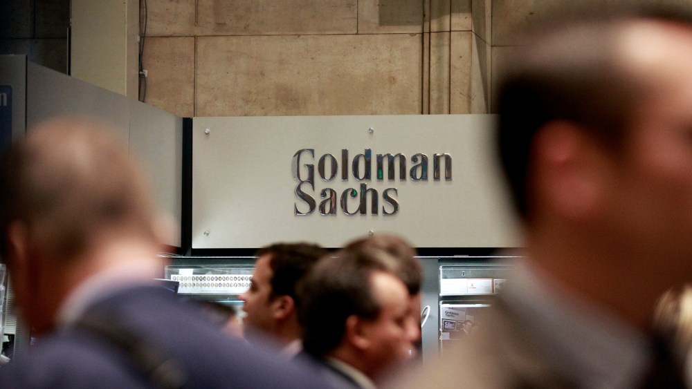 Traders work on the floor of the New York Stock Exchange near the Goldman Sachs stall on July 16, 2010.