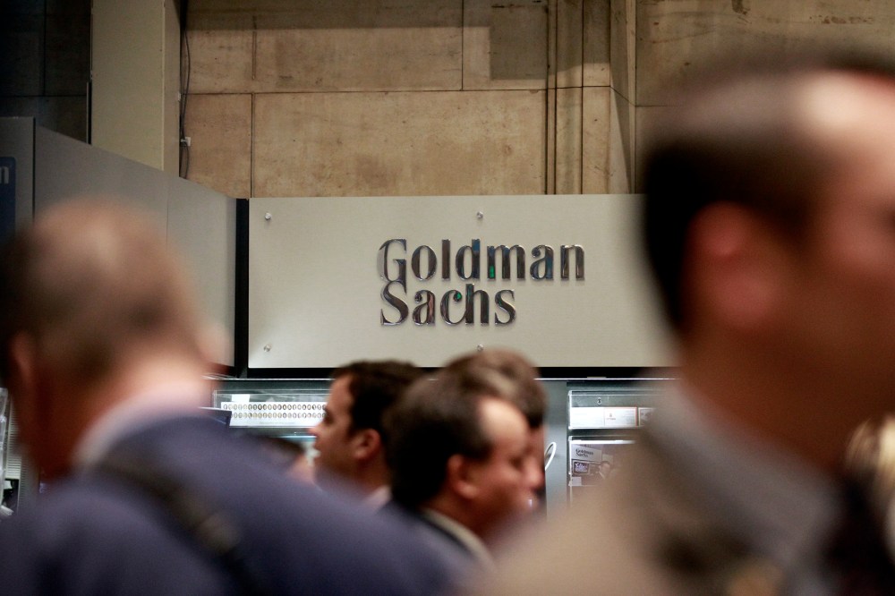 Traders work on the floor of the New York Stock Exchange near the Goldman Sachs stall on July 16, 2010.
