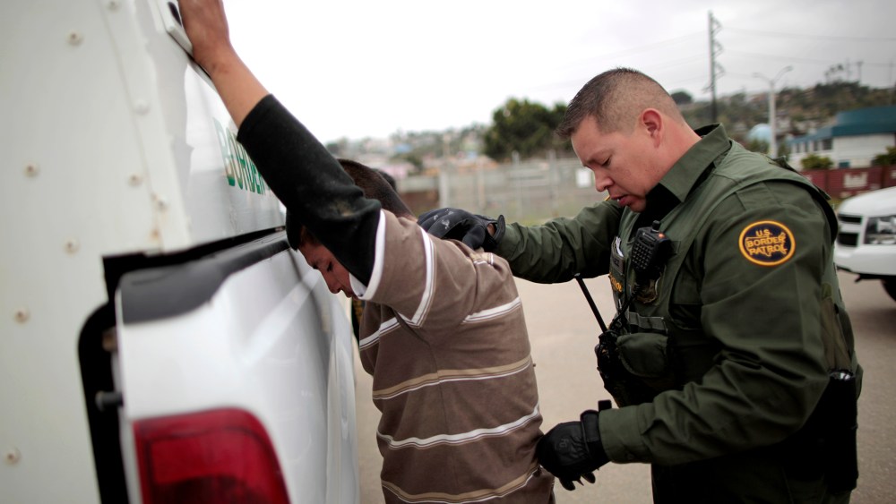 A United States border patrol agent catches an undocumented immigrant crossing from Mexico to the U.S. in San Ysidro