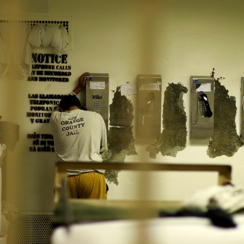 An inmate makes a phone call from his cell at the Orange County jail in Santa Ana, Calif., May 24, 2011. (Photo by Lucy Nicholson/Reuters)