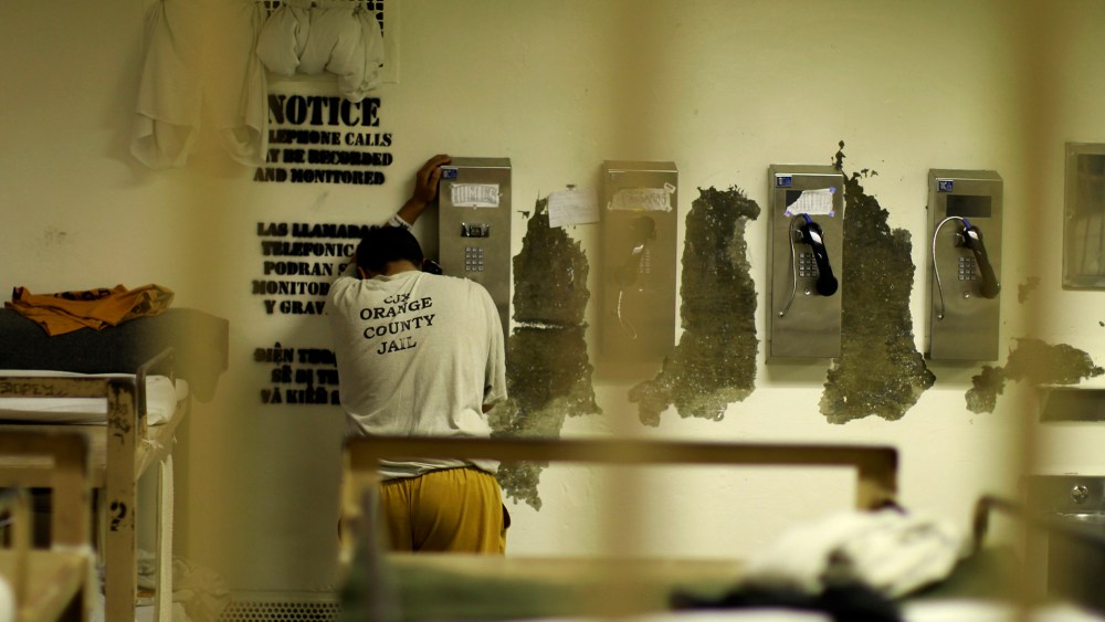 An inmate makes a phone call from his cell at the Orange County jail in Santa Ana, Calif., May 24, 2011. (Photo by Lucy Nicholson/Reuters)