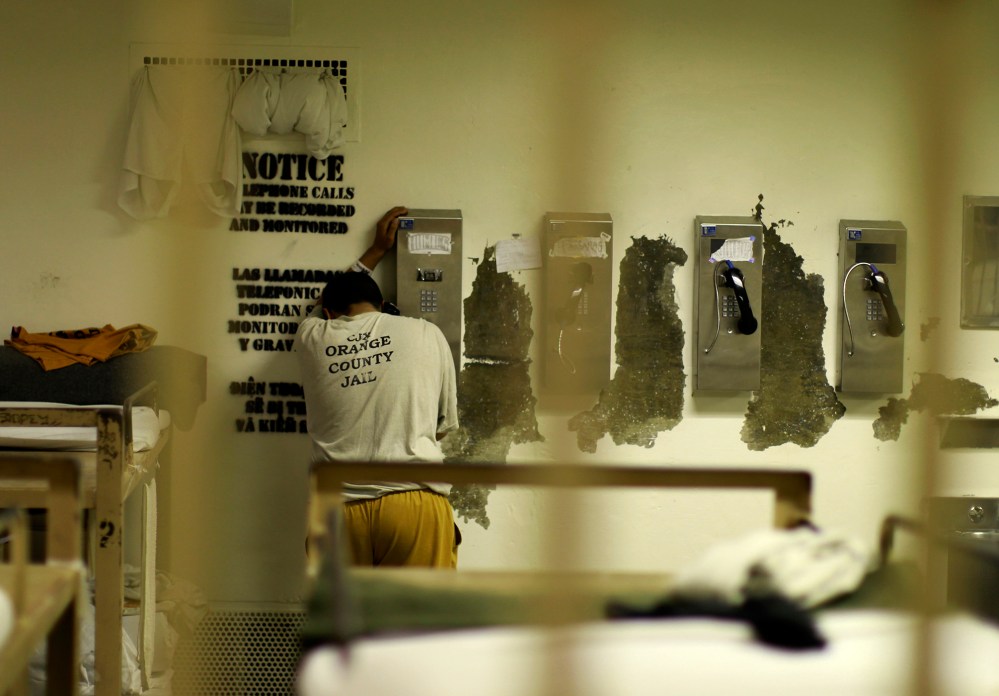 An inmate makes a phone call from his cell at the Orange County jail in Santa Ana, Calif., May 24, 2011. (Photo by Lucy Nicholson/Reuters)