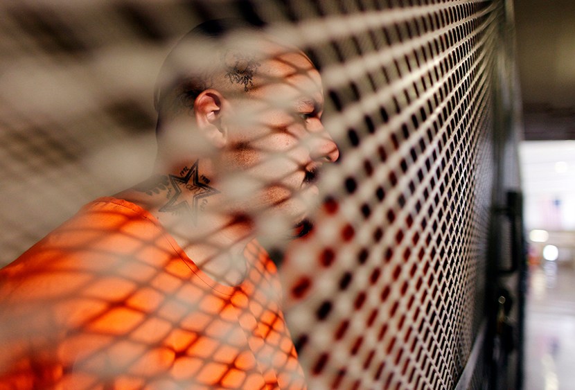 Inmate Bobby Cortez, 29, sits in a cage at the California Institution for Men state prison in Chino, California, June 3, 2011.  (Photo by Lucy Nicholson/Reuters)