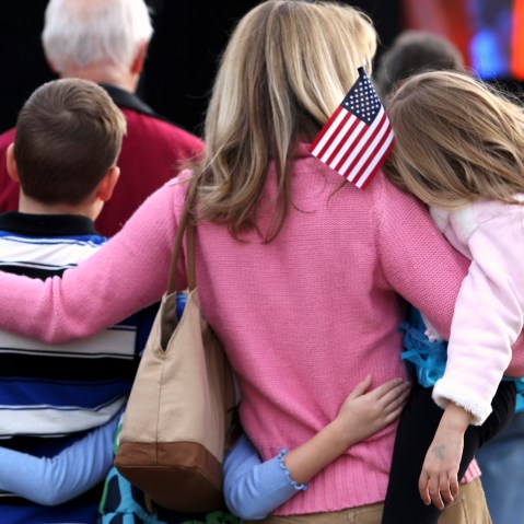 A mother huddles with her children while at an event in Myrtle Beach, South Carolina, Jan. 16, 2012.