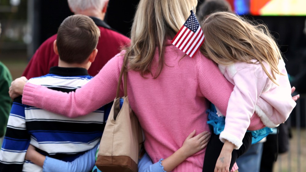 A mother huddles with her children while at an event in Myrtle Beach, South Carolina, Jan. 16, 2012.