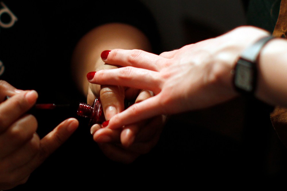 Models prepare backstage for the Bill Blass Fall/Winter 2012 collection show during New York Fashion Week