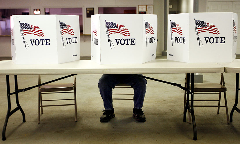 A voter casts a ballot. (Photo by Matt Sullivan/Reuters)
