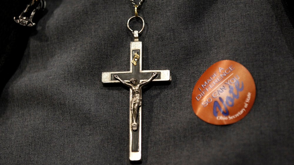 A nun wears an "I Made A Difference So Can You" voting sticker at a rally for Rick Santorum after the Ohio Republican Primary in Steubenville, Ohio, March 6, 2012.