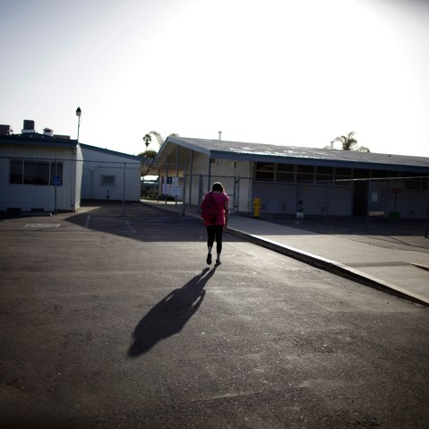 Melinda Guzman, 12, walks into her school in Port Hueneme, some 65 miles northwest of Los Angeles, California on Feb. 28, 2012.