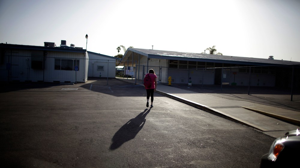 Melinda Guzman, 12, walks into her school in Port Hueneme, some 65 miles northwest of Los Angeles, California on Feb. 28, 2012.