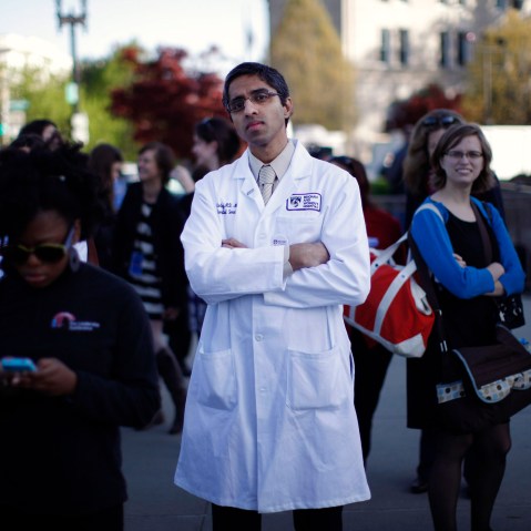 Doctor Vivek Murthy stands among other bystanders outside the Supreme Court in Washington, March 26, 2012.