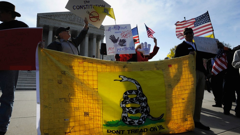Tea Party supporters rally against Obama healthcare legislation during the third and final day of legal arguments over the Patient Protection and Affordable Care Act in Washington