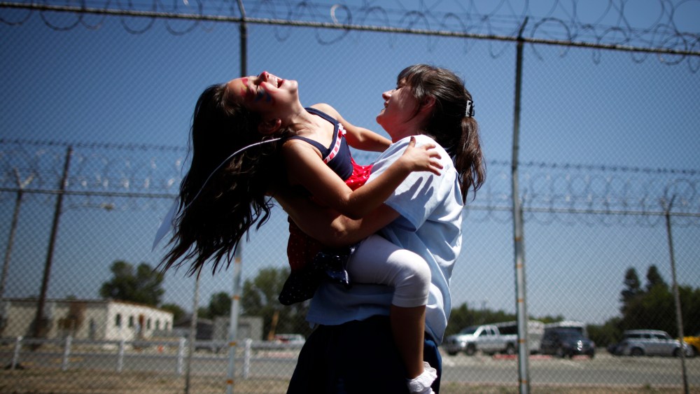 Cori Walters, 32, (R) hugs her daughter Hannah Walters, 6, at California Institute for Women state prison in Chino, California May 5, 2012.