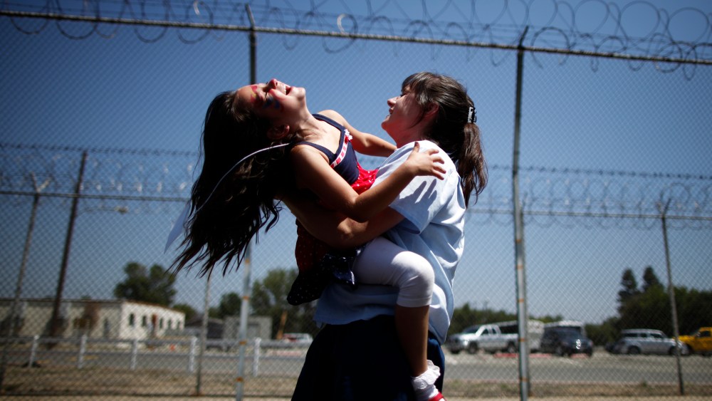 Cori Walters hugs her daughter Hannah at California Institute for Women state prison in Chino, California May 5, 2012.