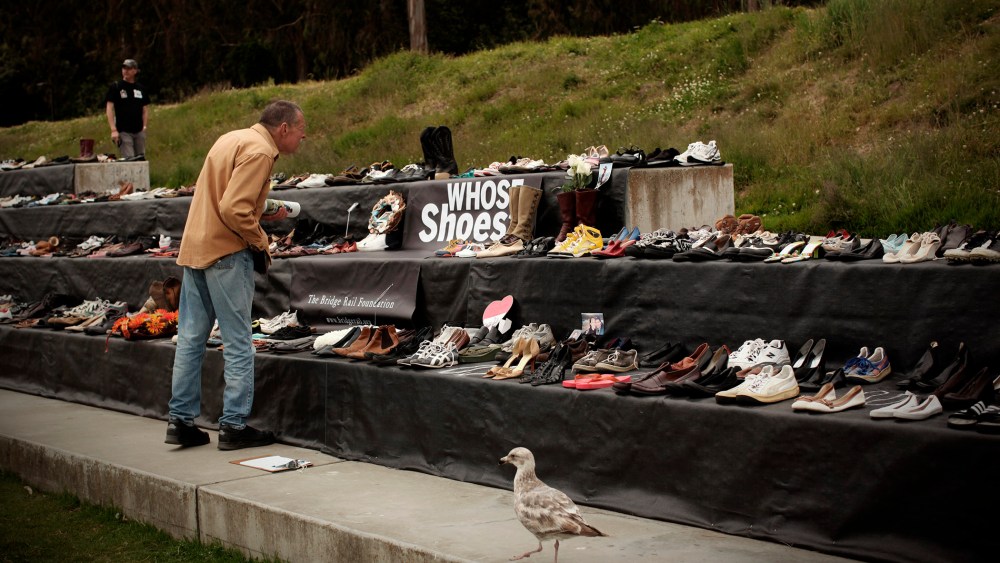 A man looks at a display of more than 1,000 pairs of shoes belonging to people who have jumped to their death from the Golden Gate Bridge in San Francisco, Calif., May 27, 2012. (Photo by Robert Galbraith/Reuters)