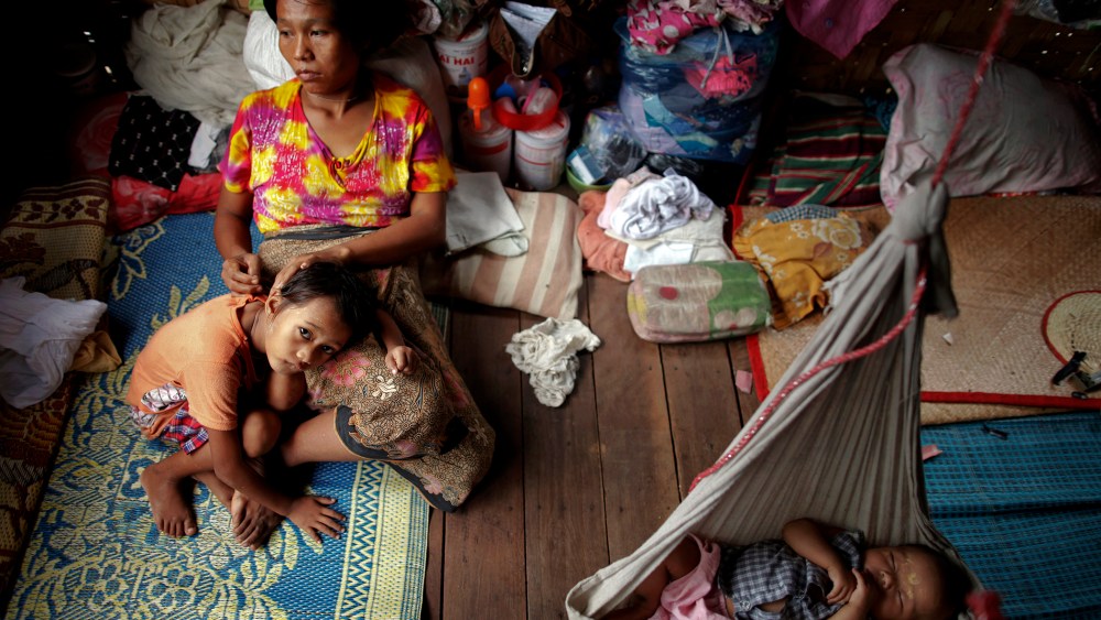 HIV-positive Ma Mon comforts her non-positive daughter Myat Noe Thu as her HIV-positive son Ei Ei Phyu sleeps in a hammock at the HIV/AIDS hospice founded by a member of the National League for Democracy (NLD) party in the suburbs of Yangon. Myanmar on Ma