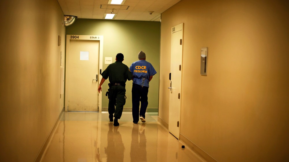 Albert Ruiz, 50, who is on death row for murder, is led down a corridor at San Quentin state prison in San Quentin, California June 8, 2012.