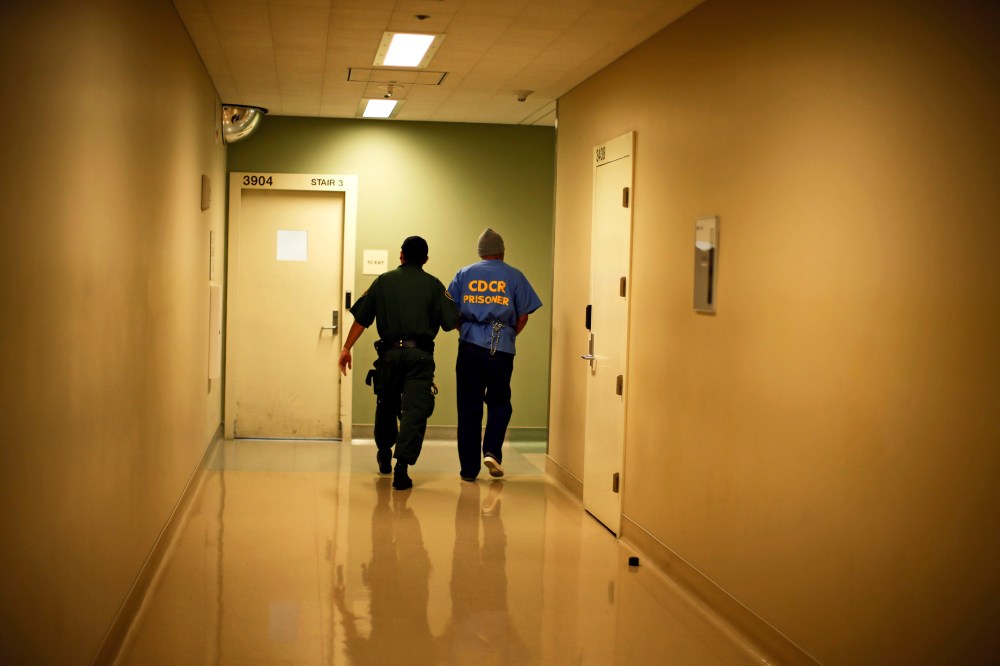 Albert Ruiz, 50, who is on death row for murder, is led down a corridor at San Quentin state prison in San Quentin, California June 8, 2012.