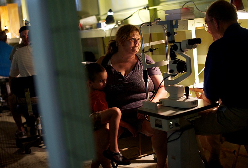 A patient has an eye exam at the Remote Area Medical (RAM) clinic in Wise, Virginia July 20, 2012.  RAM clinics bring free medical, dental and vision care to uninsured and under-insured people across the country and abroad.   (Photo by Mark Makela/AP)