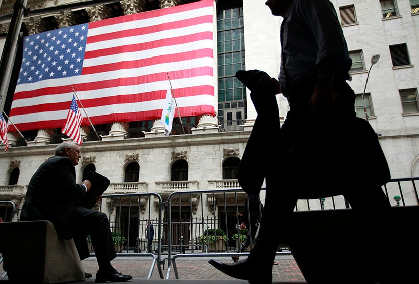 Morning commuters are seen outside the New York Stock Exchange