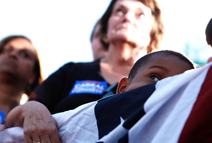 Supporters listen to U.S. President Obama speaking at a campaign event at Loudoun County High School in Leesburg