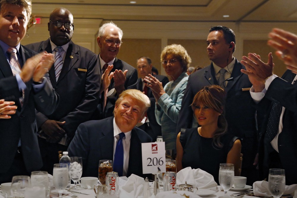 Donald Trump and his wife Melania are applauded before a dinner hosted by the Sarasota Republican Party honoring him as Statesman of the Year in Sarasota, Fla., August 26, 2012. (Photo by Mike Carlson/Reuters)