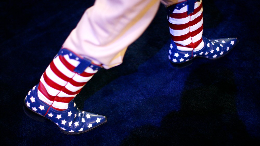 A participant walks the convention floor in Stars and Stripes cowboy boots during the second day of the Republican National Convention, Aug. 28, 2012 in Tampa, Fla.