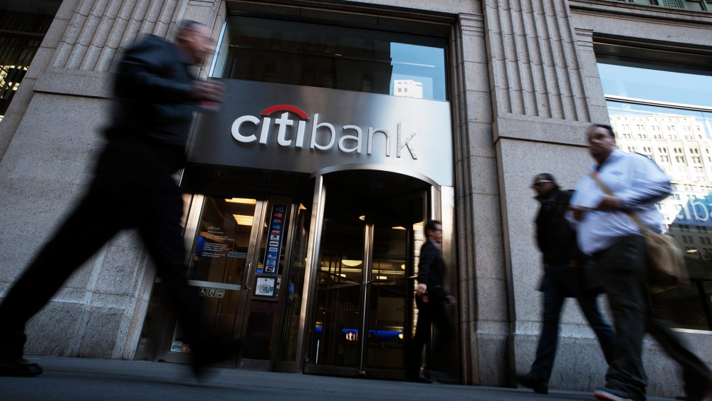 Passersby walk in front of a Citibank branch in New York
