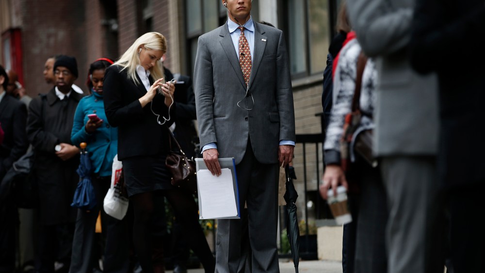 Job seekers stand in line to meet prospective employers at a career fair in New York City