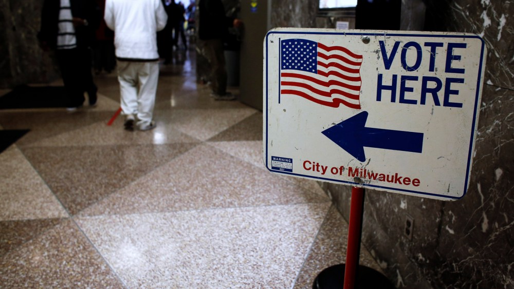 Residents wait in line during lunch hour to cast their early votes in the upcoming U.S. presidential elections in Milwaukee
