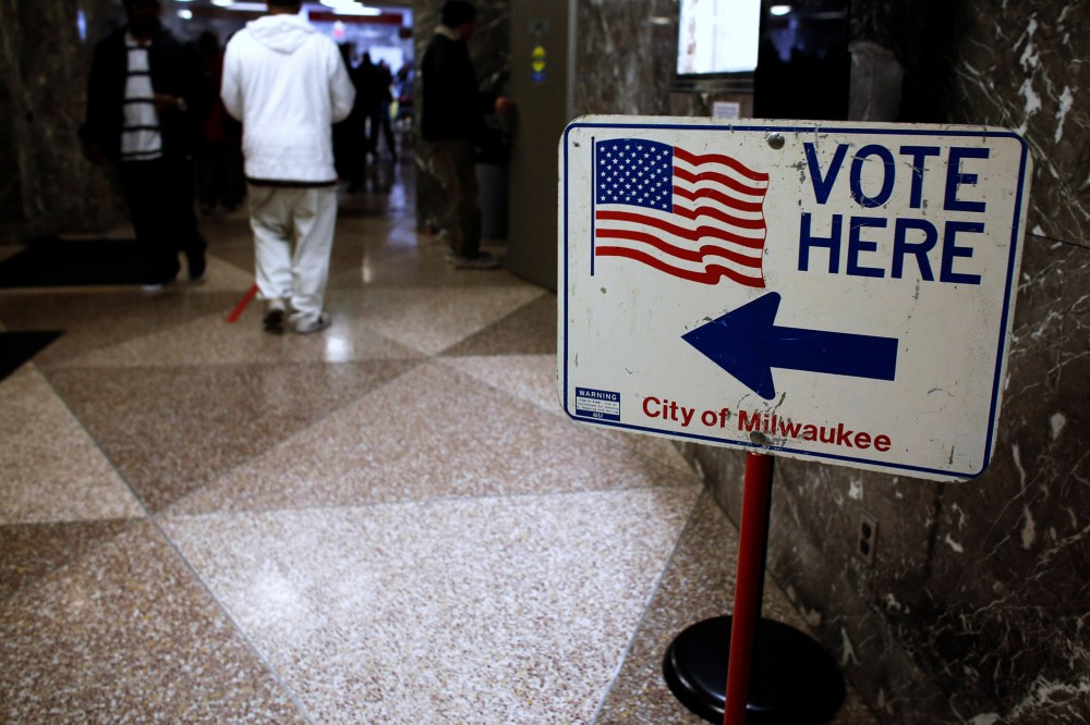 Residents wait in line during lunch hour to cast their early votes in the upcoming U.S. presidential elections in Milwaukee