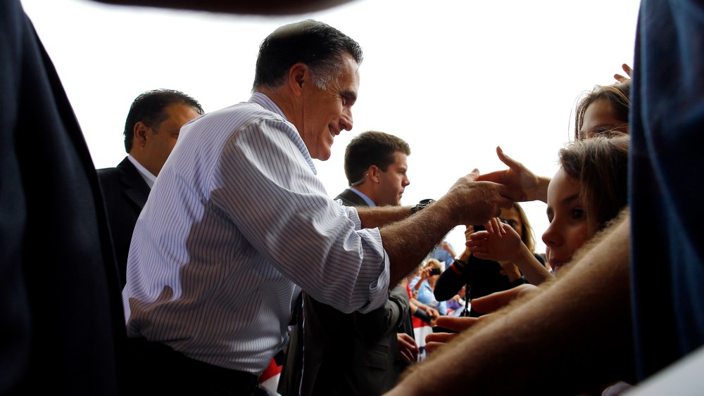 Republican presidential nominee Romney greets audience members at a campaign rally at the airport in Sanford
