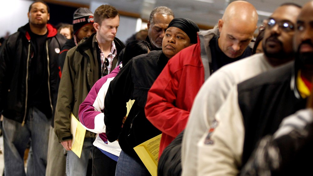 Voters wait in line to cast their ballots at the Franklin County in-person absentee voting location in Columbus
