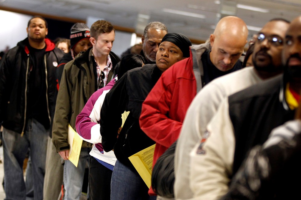Voters wait in line to cast their ballots at the Franklin County in-person absentee voting location in Columbus