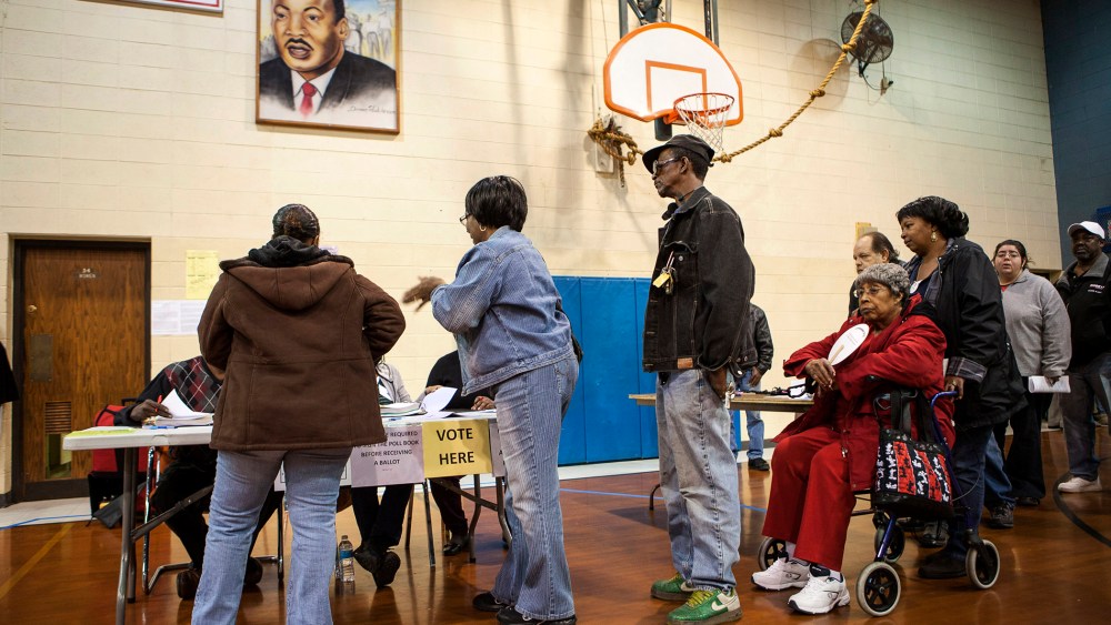 Voters sign in to vote at the Dr. Martin Luther King Community Center for the U.S. presidential election in Racine, Wisconsin on Nov. 6, 2012.