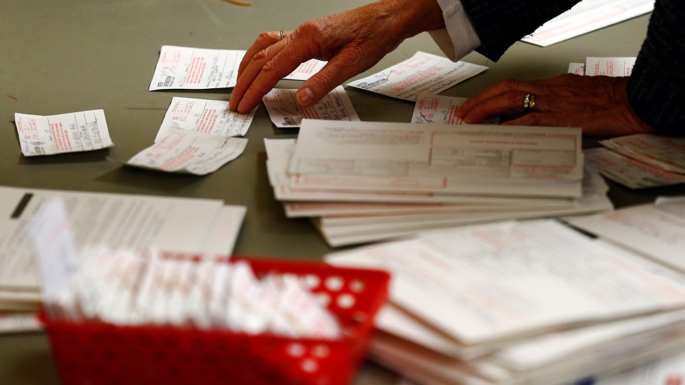A poll worker looks at voter authorization forms in Charlotte, North Carolina.
