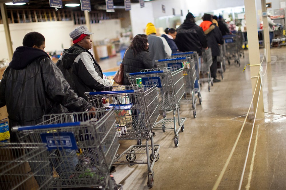 Clients wait in line to shop for food at St. Vincent de Paul food pantry in Indianapolis