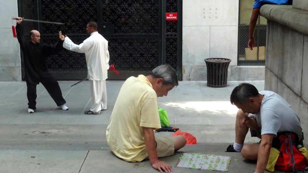 Local residents relax in a square in Chinatown in New York, Aug, 6, 2012. (Photo by Charles Platiau/Reuters)