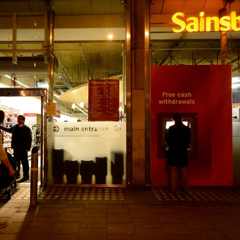 A security guard locks the door to a Sainsbury store in central London on Dec. 23, 2012.