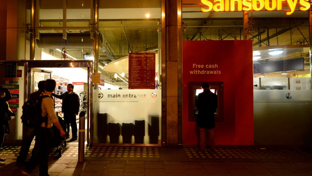 A security guard locks the door to a Sainsbury store in central London on Dec. 23, 2012.