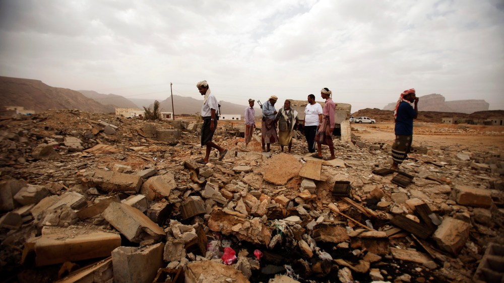 Tribesmen stand on the rubble of a building destroyed by a U.S. drone strike that killed Abdulrahman al-Awlaki, the son of slain U.S.-born cleric Anwar al-Awlaki.