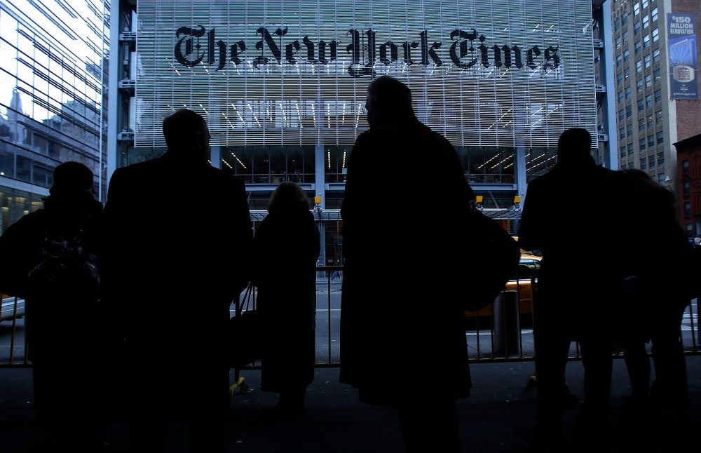 People line up for taxi across the street from the New York Times head office in New York, Feb. 7, 2013. (Photo by Carlo Allegri/Reuters)