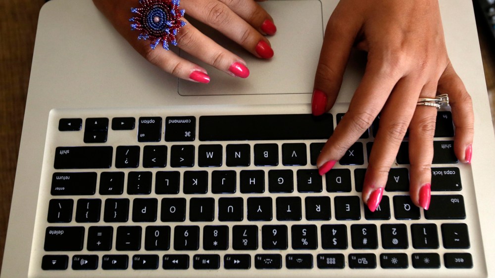 The hands of Malini Agarwal, blogger-in-chief of missmalini.com, are pictured as she blogs from her living room in Mumbai