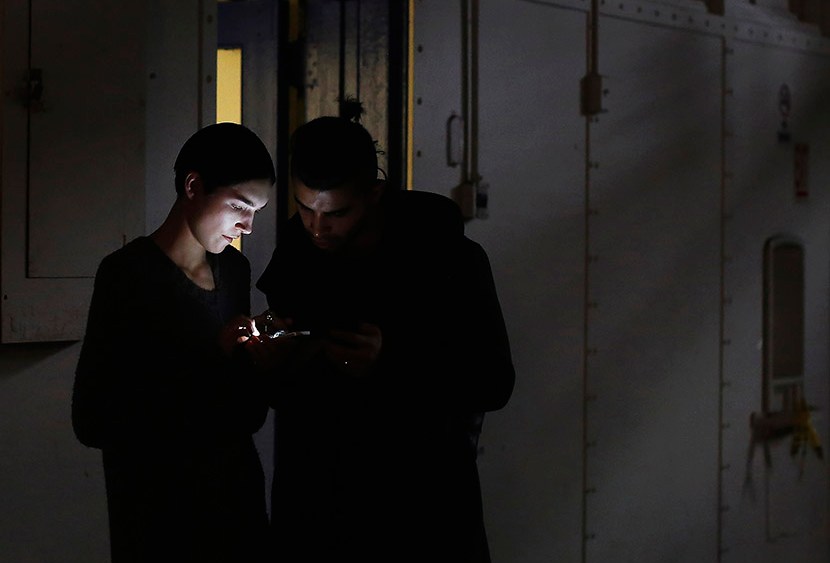 Models look at a mobile phone during New York Fashion Week on February 11, 2013.  (Photo by Shannon Stapleton/Reuters)
