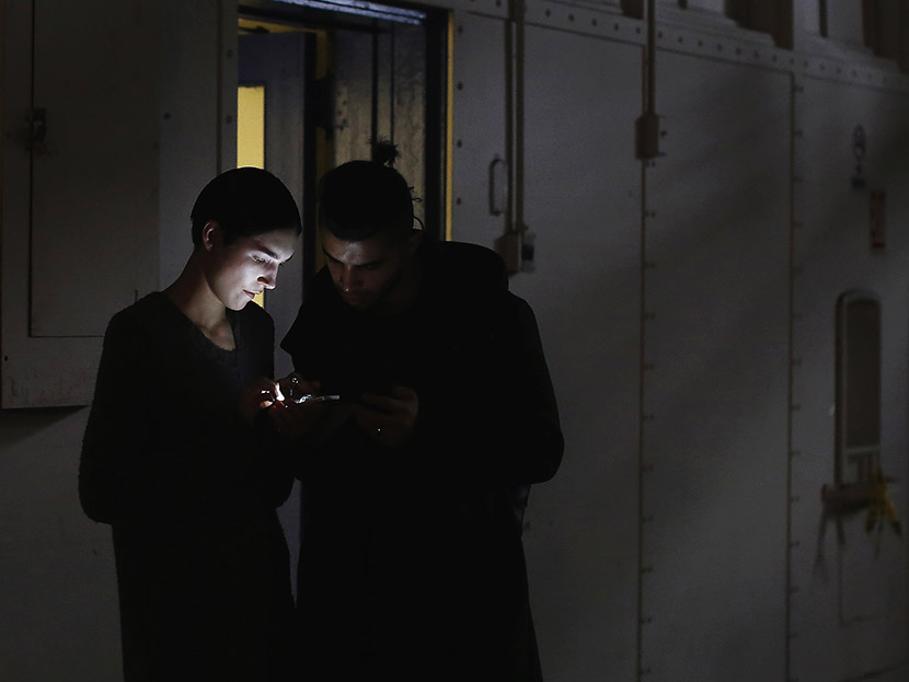 Models look at a mobile phone during New York Fashion Week on February 11, 2013. (Photo by Shannon Stapleton/Reuters)