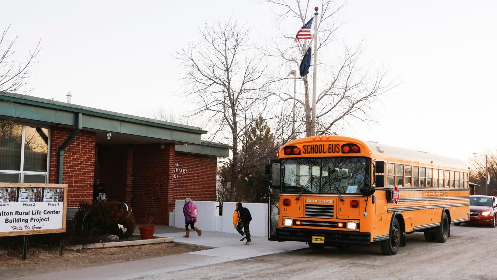 Students arrive at the Walton Rural Life Center Elementary School, in Walton, Kansas, January 18, 2013.