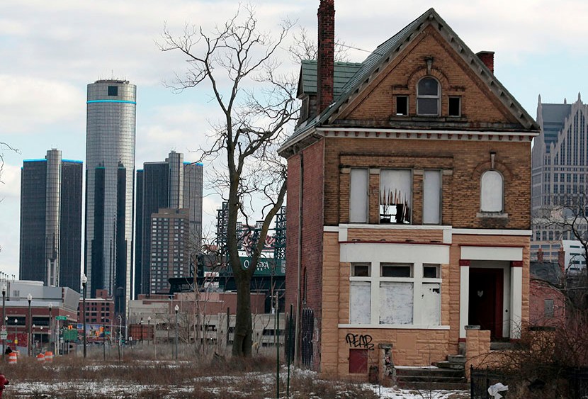 A vacant, boarded up house is seen in the once thriving Brush Park neighborhood with the downtown Detroit skyline behind it in Detroit, Michigan March 3, 2013. (Photo by Rebecca Cook/Reuters)