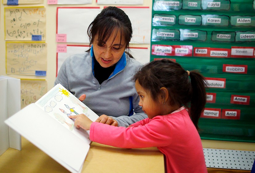 Paola Garcia reads a book with her three-year-old daughter Emily at Action for Boston Community Development's (ABCD) Head Start program in the Roslindale neighborhood of Boston, Massachusetts March 5, 2013. According to ABCD, 95 percent of the money...